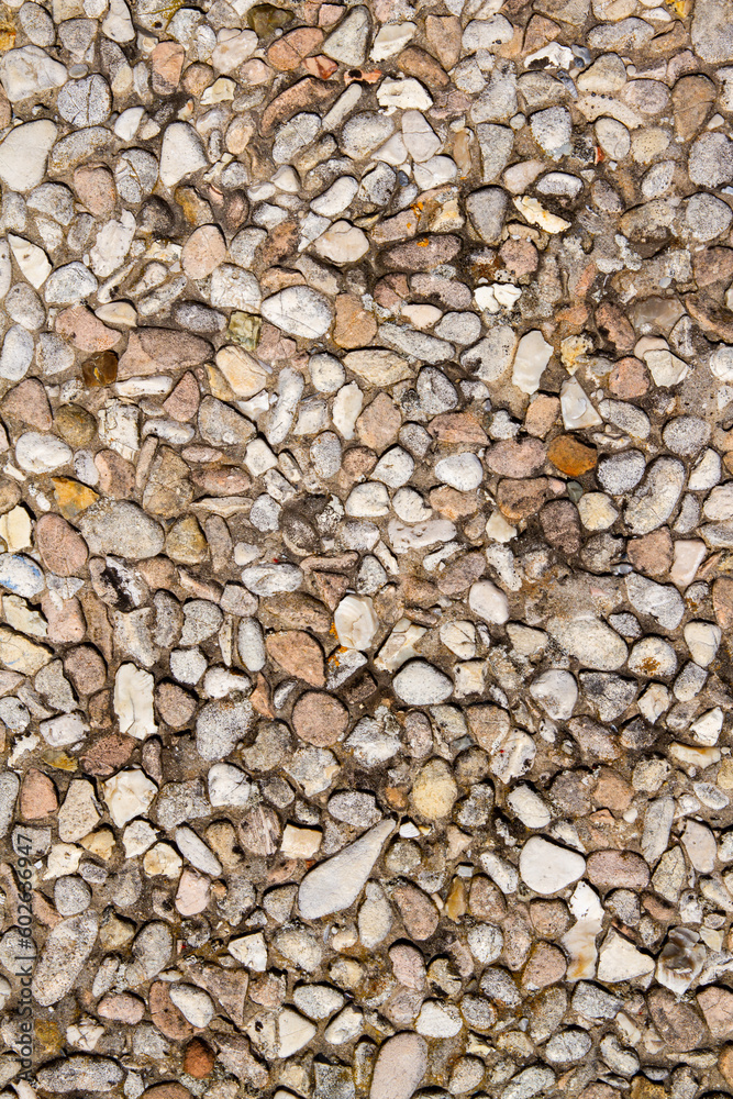A sidewalk of small stones. Fine pebble texture. A sidewalk of small stones. Fine pebble texture.