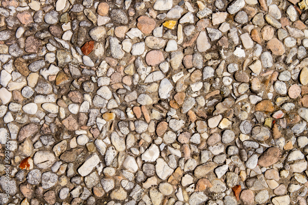 A sidewalk of small stones. Fine pebble texture. A sidewalk of small stones. Fine pebble texture.