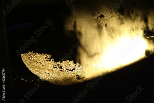 abstract image of backlit wine tartrate crystals in a bottle of white wine photo