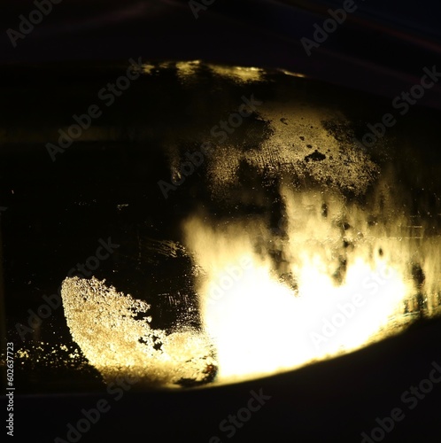 abstract image of backlit wine tartrate crystals in a bottle of white wine photo