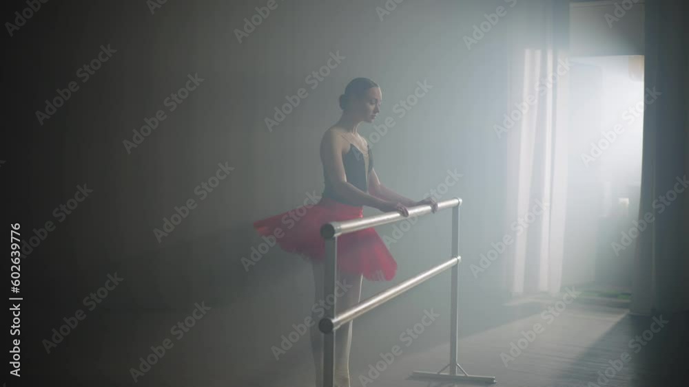 Ballerina improves her posture and technique of performing ballet exercises by barre. Classes at the barre strengthen the muscles of ballerinas. High quality 4k footage