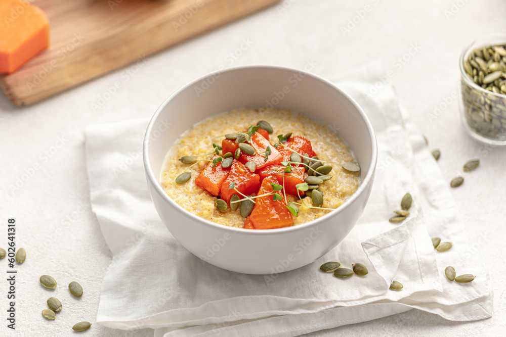 Portion of healthy breakfast millet porridge with baked pumpkin Portion of healthy breakfast millet porridge with baked pumpkin