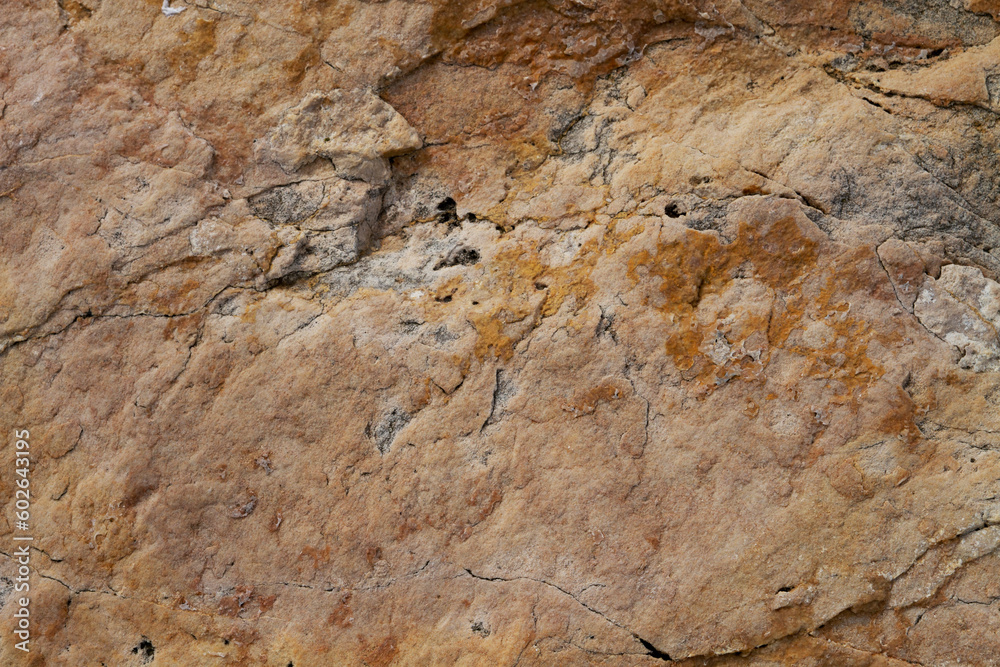 The texture of the stone is notched and mottled. holes notches grooves on the stone.