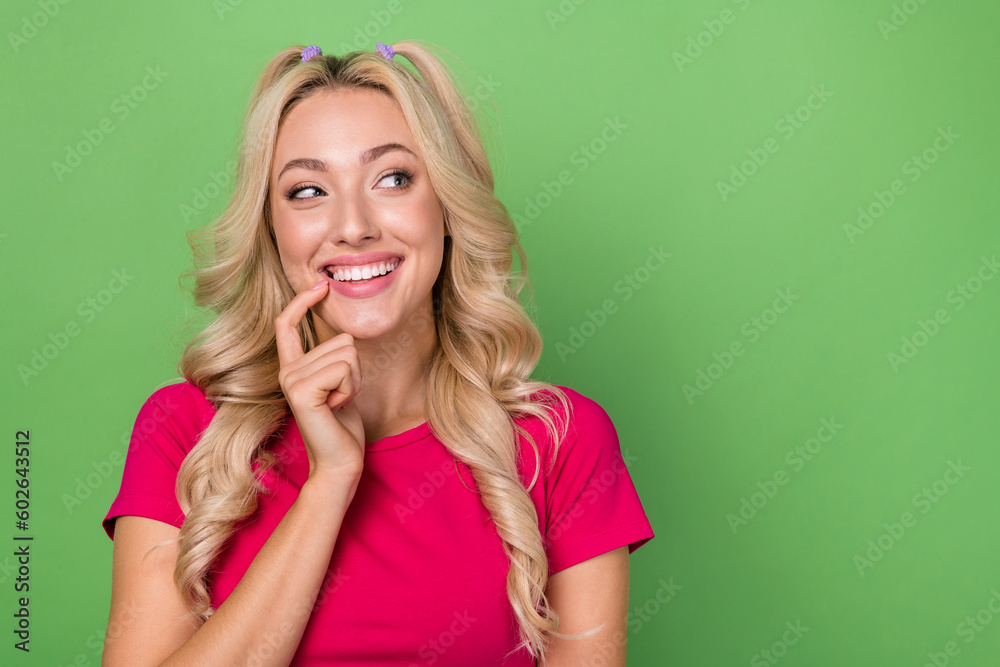 Photo of adorable tricky lady dressed pink t-shirt finger mouth looking emtpy space isolated green color background Photo of adorable tricky lady dressed pink t-shirt finger mouth looking emtpy space isolated green color background