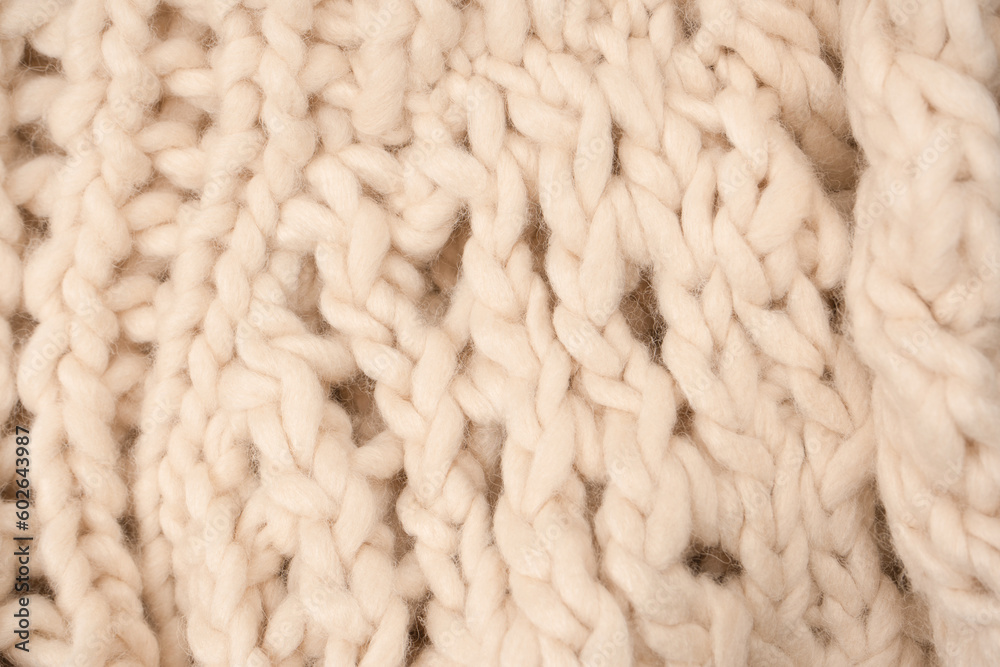 A fragment of beige knitted fabric, knitted from white sheep wool. A fragment of beige knitted fabric, knitted from white sheep wool.