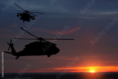 Silhouettes of helicopters on background of sunset. Greeting card for Veterans Day, Memorial Day, Air Force Day. USA celebration. © hamara