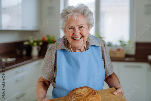 Portrait of senior woman with fresh baked bread.