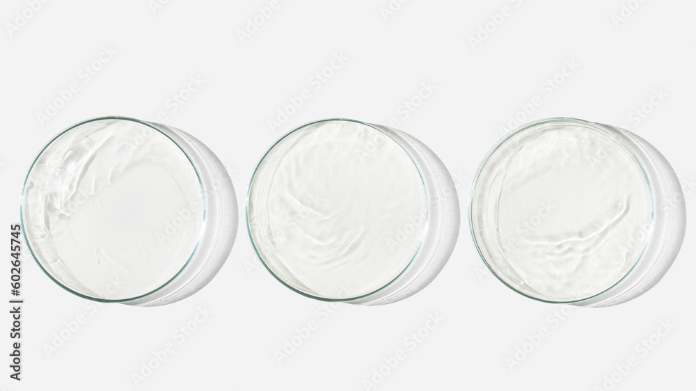 Three Petri dishes on a light background with liquid, water. Splashes of water. Waves in the petri dishes. View from above. Laboratory Three Petri dishes on a light background with liquid, water. Splashes of water. Waves in the petri dishes. View from above. Laboratory
