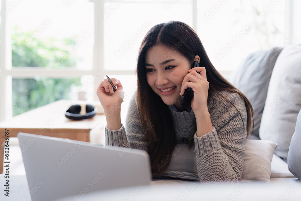 Attractive Asian woman resting comfortable living room and using mobile phone, Relax, Sofa, Lifestyle Attractive Asian woman resting comfortable living room and using mobile phone, Relax, Sofa, Lifestyle