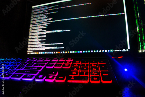 Multicolored keyboard on the background of computer code	
