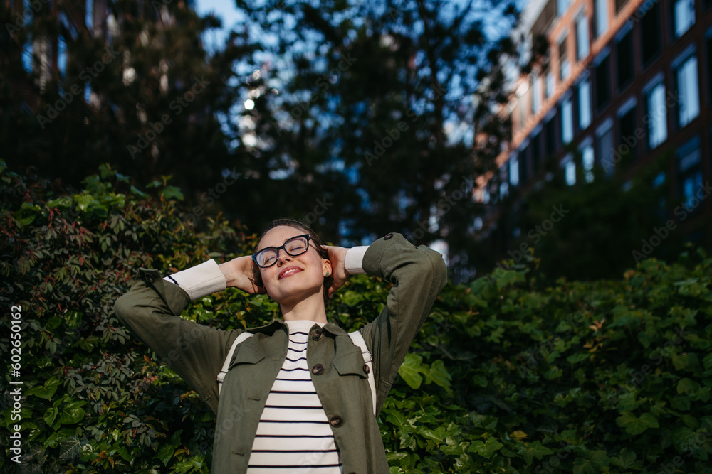 Portrait of young woman enjoying nature in city park. Portrait of young woman enjoying nature in city park.