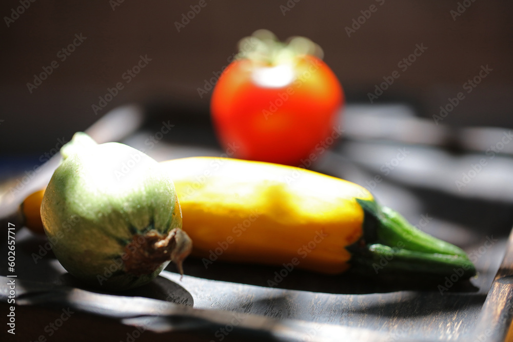 three different vegetables on a wooden plate isolated