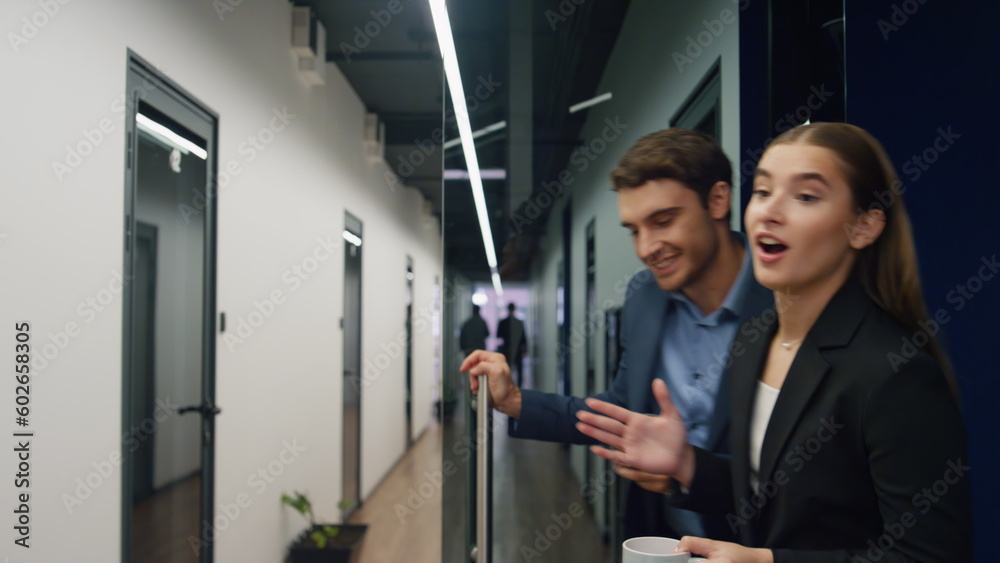 Office managers talking lunch break. Joyful business partners holding coffee Office managers talking lunch break. Joyful business partners holding coffee