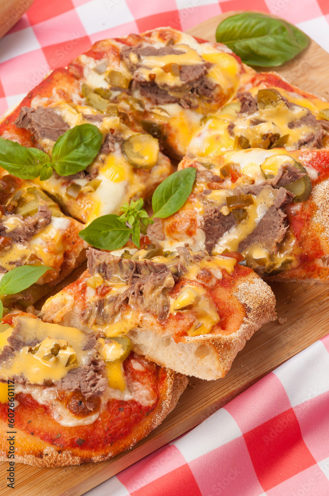 pizza with beef gherkins and jalapeno, mozzarella cheese and cheddar sauce pizza with beef gherkins and jalapeno, mozzarella cheese and cheddar sauce