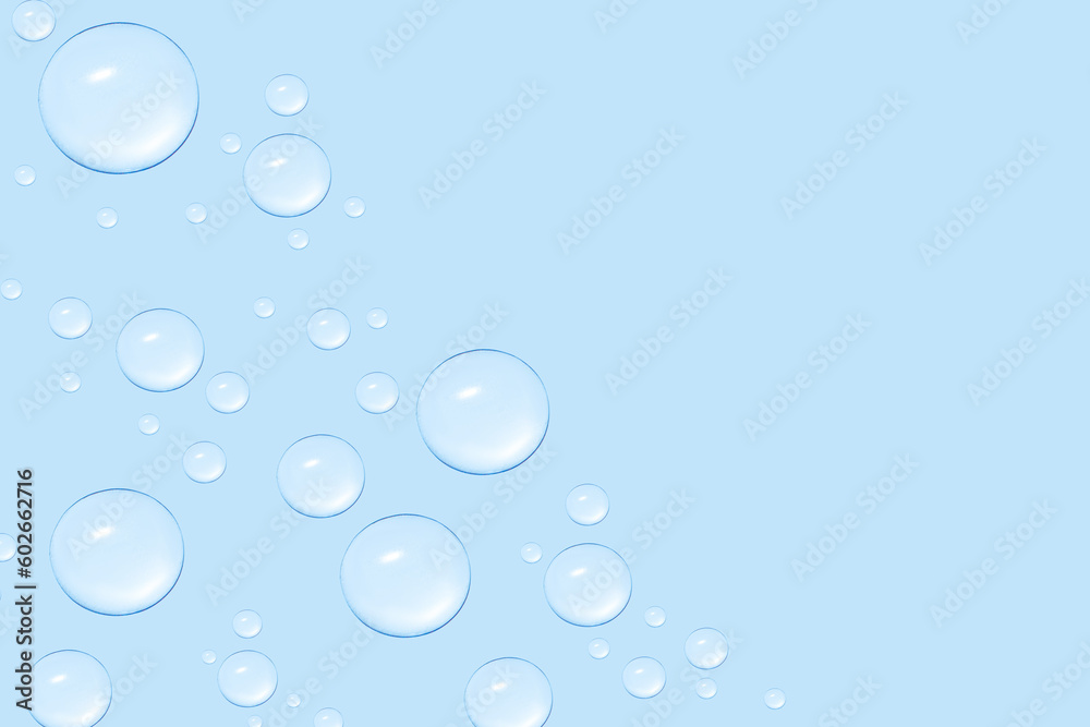 Drops of transparent gel or water in different sizes. On a blue background.