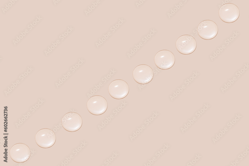 Drops of transparent gel or water in a row. On a beige background.