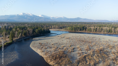 Wallpaper Mural Aerial view of mountain river in taiga. Forest in early spring in sunset time. Siberian or Canadian landscape from above. Torontodigital.ca