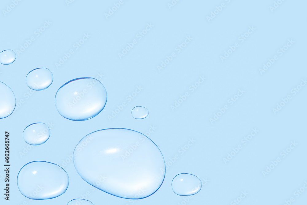 Drops of transparent gel or water in different sizes. On a blue background. Drops of transparent gel or water in different sizes. On a blue background.