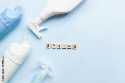 Flat lay spring from wooden letters on a blue background. Cleaners. Cleaning. Cleaning bottle mockup