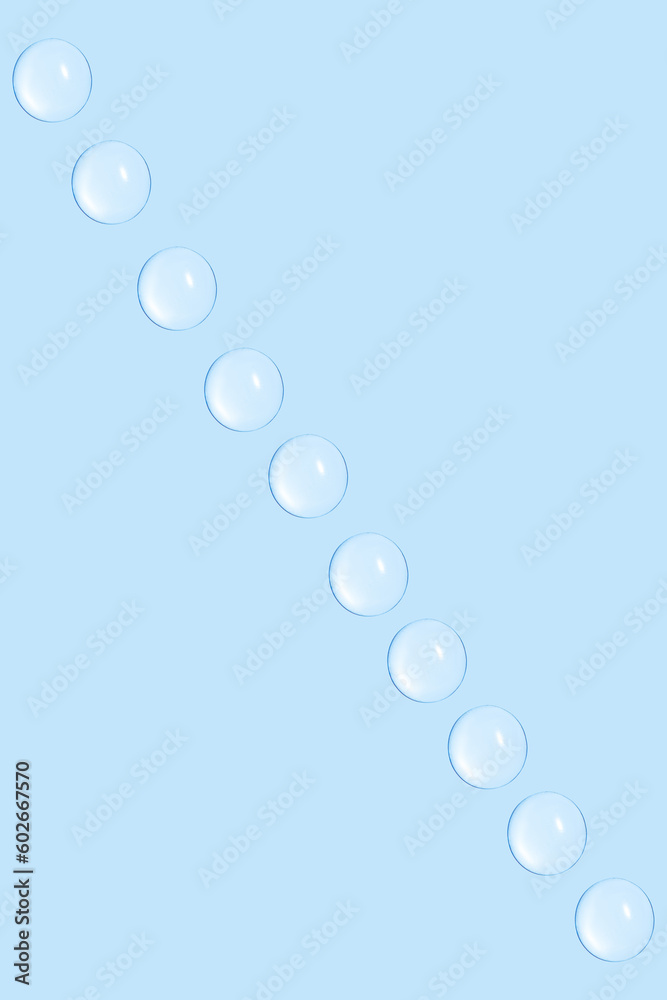 Drops of transparent gel or water in a row. On a blue background. Drops of transparent gel or water in a row. On a blue background.