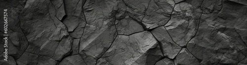 Volumetric rock texture with cracks. Black stone background with copy space for design. Wide banner