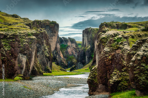 Rugged moss Fjadrargljufur canyon with Fjadra river flowing through in summer at Iceland