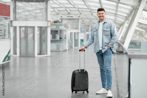 Man Traveler Posing With Suitcase Luggage Standing At Airport Indoor
