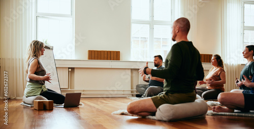 Yoga instructor teaching breathing exercises photo