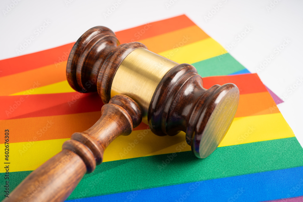 Gavel for judge lawyer on rainbow flag, symbol of LGBT pride month celebrate annual in June social of gay, lesbian, bisexual, transgender, human rights.