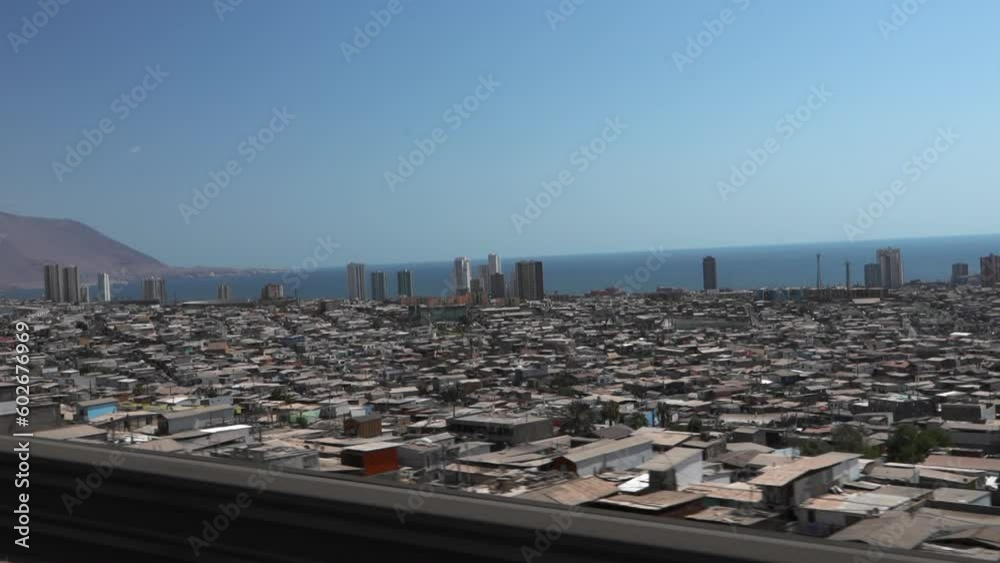 cityscape of Iquique behind a huge dune in northern Chile, right the edge of the Atacama desert and the cold pacific ocean. cityscape of Iquique behind a huge dune in northern Chile, right the edge of the Atacama desert and the cold pacific ocean.