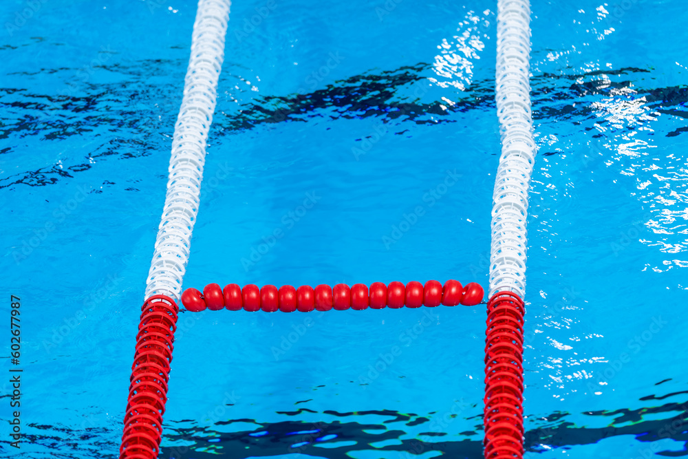 The view of an empty public swimming pool indoors. Lanes of a competition swimming pool. Horizontal sport theme poster, greeting cards, headers, website and app