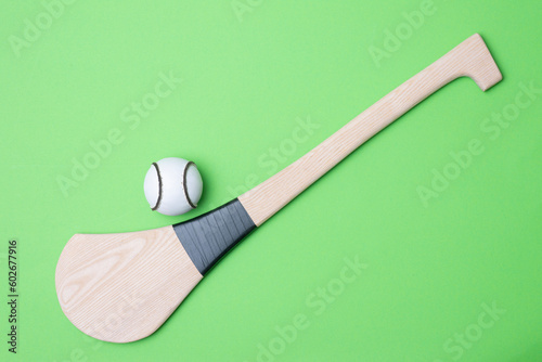 Hurling bat and sloitar on green background. Horizontal sport theme poster, greeting cards, headers, website and app