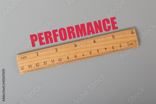 Wooden ruler with text PERFORMANCE. Performance concept.
