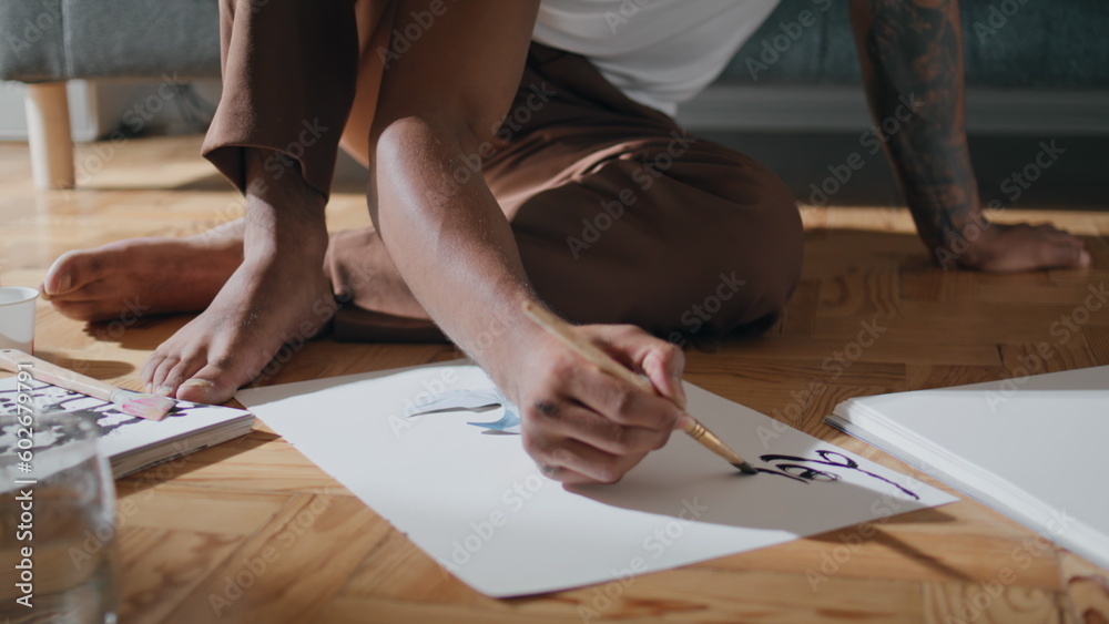 Young guy sketching paper at flat closeup. Black hair artist preparing painting Young guy sketching paper at flat closeup. Black hair artist preparing painting