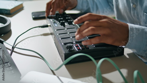 Man hands using console keyboard closeup. Unknown dj pushing buttons mixing song
