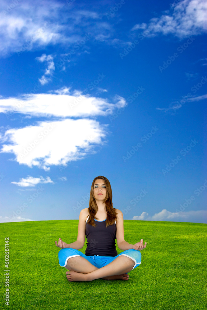 Beautiful athletic woman making yoga on a beautiful green landscape Beautiful athletic woman making yoga on a beautiful green landscape