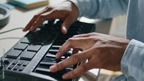 Closeup equalizer keyboard man hands touching at home closeup. Dj arms mixing