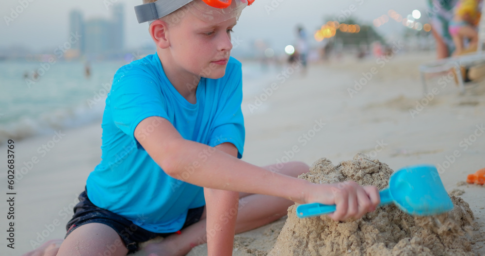 Boy in swimsuits play in the sand on the beach. Boy in swimsuits play in the sand on the beach.