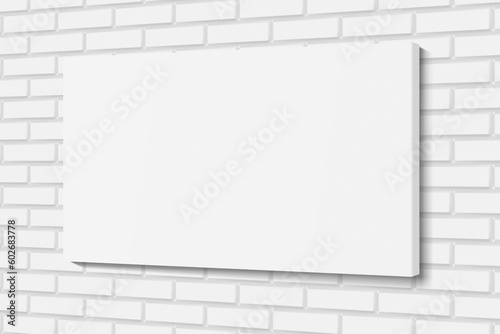 Blank white canvas frame on white brick wall