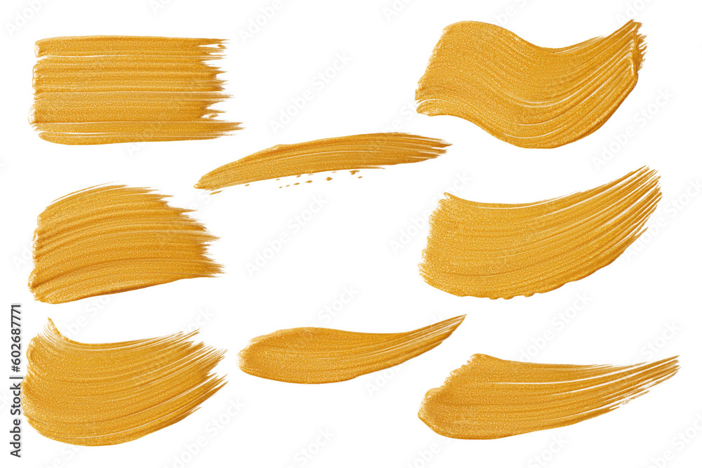a set of strokes of gold paint on a white background. a set of strokes of gold paint on a white background.