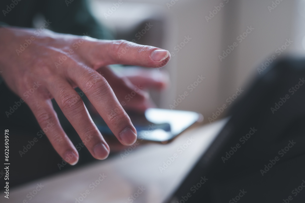 businessman pointing at blurred screen in blurred office background