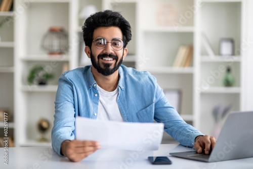 Handsome Indian Male Freelancer Working With Papers At Home Office