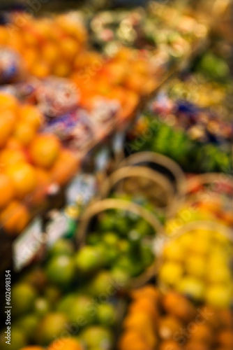 Blurred fruit stacks at grocery store.