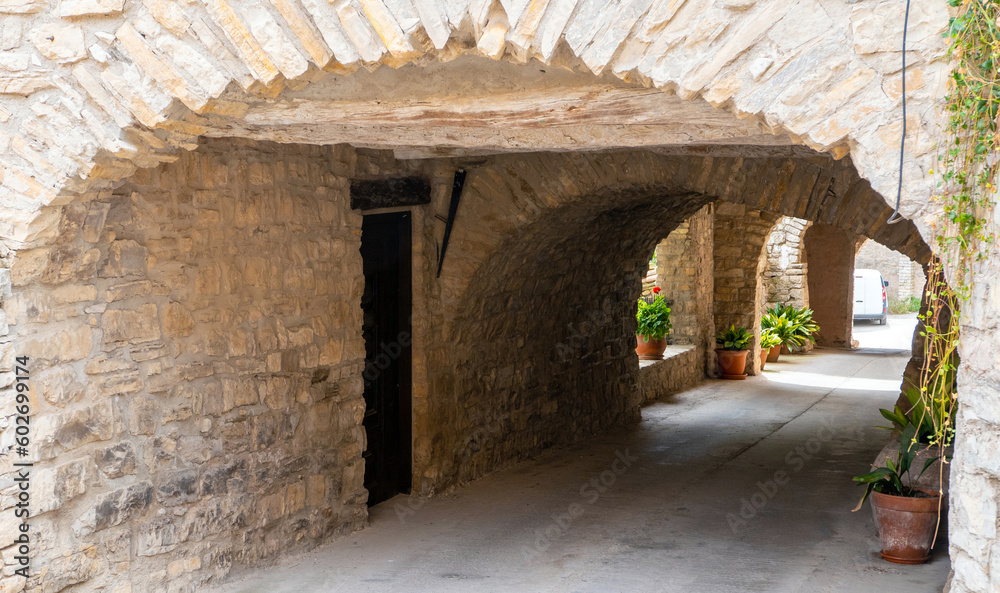 L'Astor (Anoia), Catalunya, Spain - May 14, 2023: Narrow cobblestone street in the medieval village