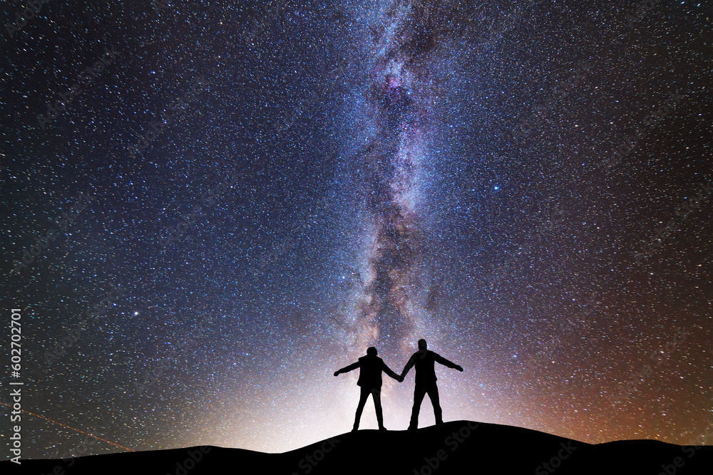 Fototapeta premium Fantasy landscape, silhouette of losers standing on the hill, on the milky way galaxy background.