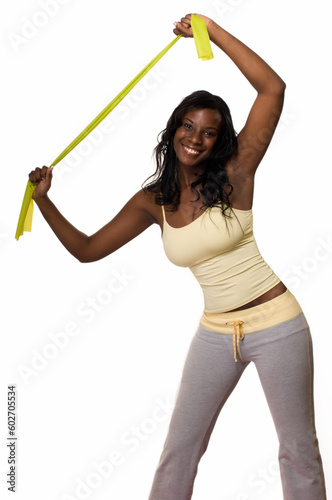 Attractive African American woman wearing workout attire standing stretching