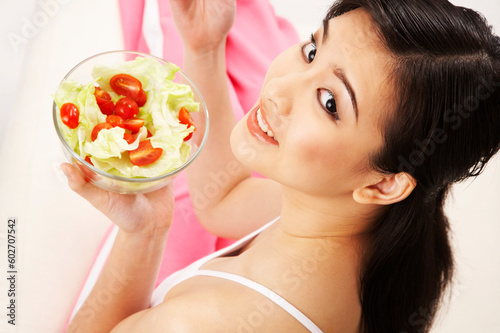 young woman eating salad