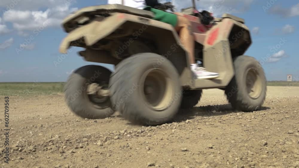 People riding quad bike through a field, atv moto People riding quad bike through a field, atv moto