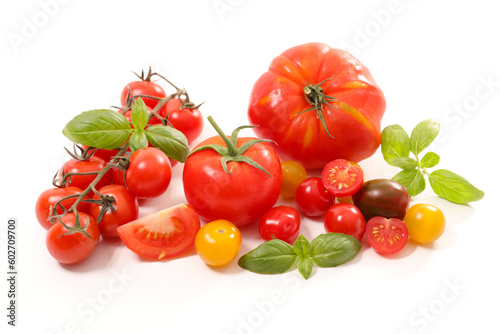 various colorful tomatoes and basil isolated on white background
