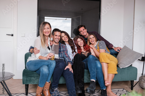 Group of friends sitting on a sofa all together at a party at home. Concept  friendship  lifestyle  fun